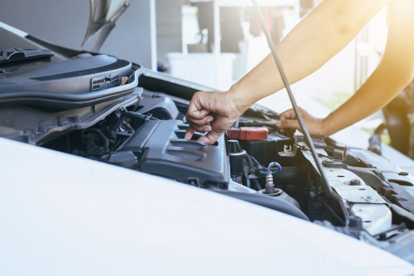 Open hood of a car closing the oil seal